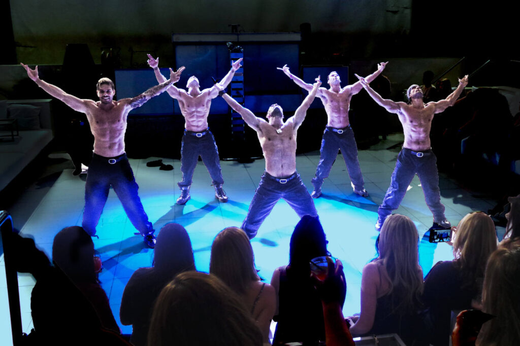 hollywood men stripper on stage arms raised
